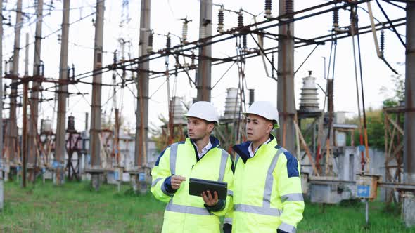 Industrial Workers Using a Digital Tablet on Site