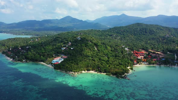 Tropical flying tourism shot of a white sandy paradise beach and turquoise sea background in vibrant