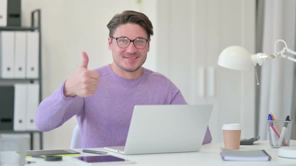 Thumbs Up By Middle Aged Man with Laptop 