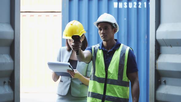 Businesswoman and worker checking container