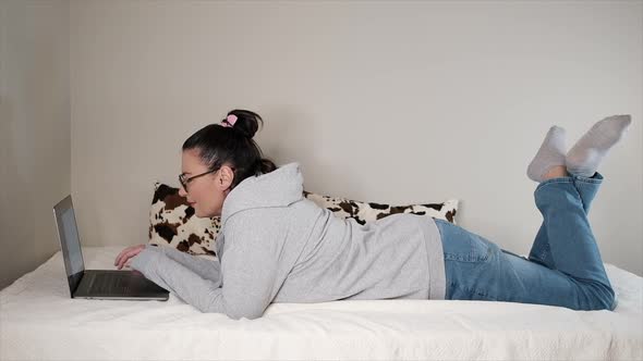 Woman Working On Laptop at Home