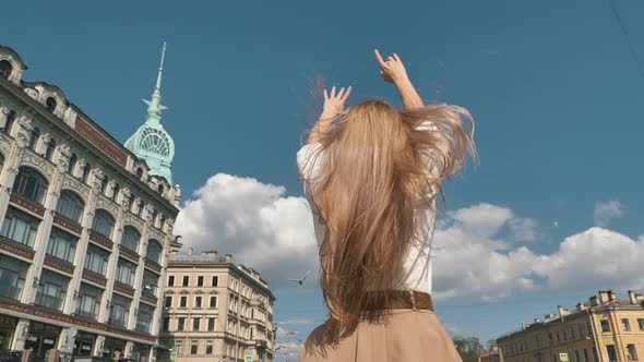 Blonde with Loose Hair Waved By Wind Poses Raising Hands