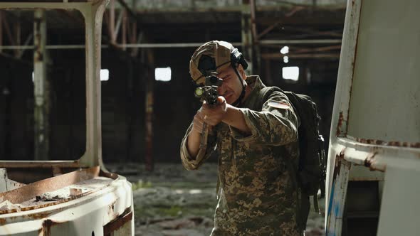 American Soldier Aiming at Sight in Destroyed Building