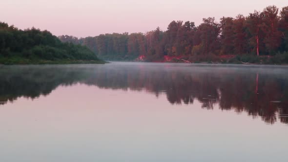 Beautiful calm sunrise dawn on river, magic mist