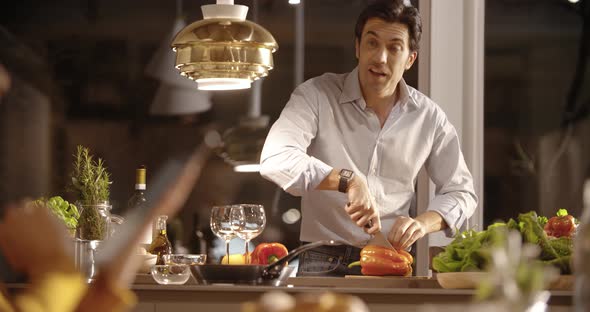 Man Prepare Dinner at Home While Woman Drink Wine