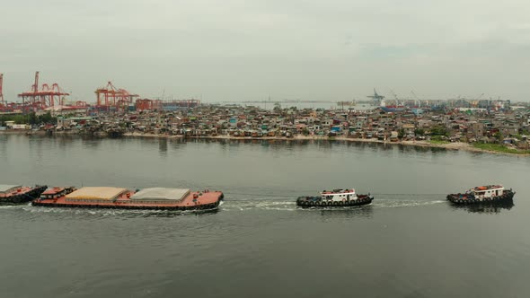 Tugboat Pulling Heavy Loaded Barge