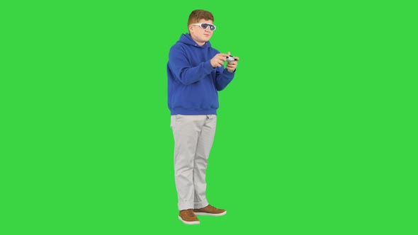 Teenager Actively Playing Video Game on a Green Screen Chroma Key