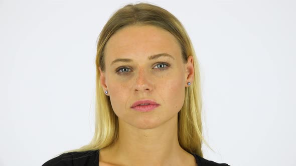 A Young Beautiful Woman Looks at the Camera - Face Closeup - White Screen Studio