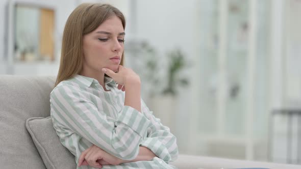 Pensive Young Woman Thinking About Something at Home 