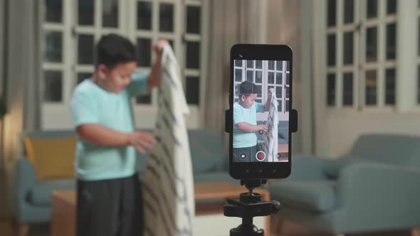 Display Smartphone Of Asian Little Boy Shows Trick With Disappearing While Recording Video