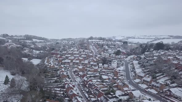 High descending drone shot of snowy Exeter subburbs