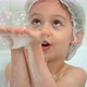 Little Girl Bathes and Plays with Soap Bubbles in Bath - VideoHive Item for Sale