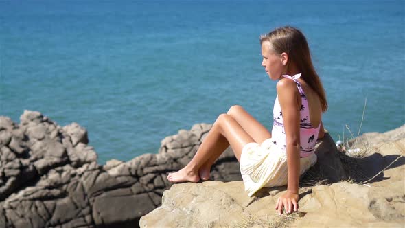 Happy Kid Outdoor on Edge of Cliff Seashore