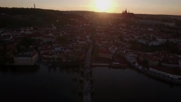 Charles Bridge and Prague panorama, aerial view at sunset