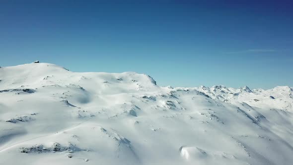 Aerial drone view of snow covered mountains in the winter.