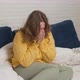 Woman in Sweater Sits on Bed and Coughs and Sneezes - VideoHive Item for Sale