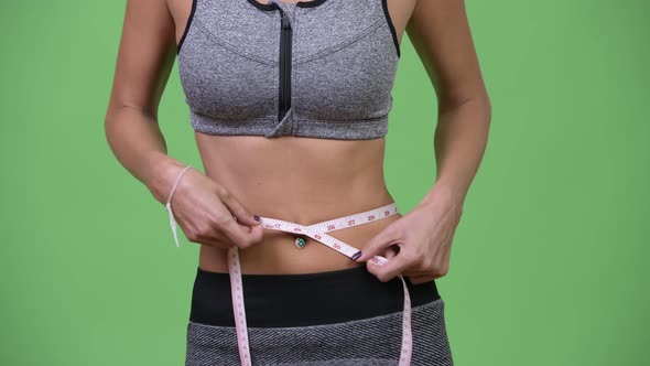 Young Woman Measuring Her Fit and Healthy Body