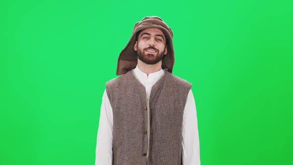Portrait of a Cheerful Man of Arab Appearance in Traditional Clothes a Man on the Background of a