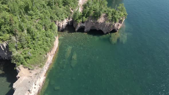 Aerial view of sea caves and rock formations at Lake Superior shoreline in Minnesota during summer