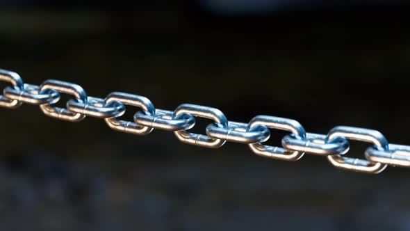 A metal chain is blown to pieces. Breaks chains. Regains freedom. Break free.