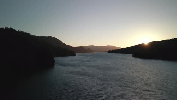 Bird'seye View of the Sunrise Over the River with Hilly Terrain