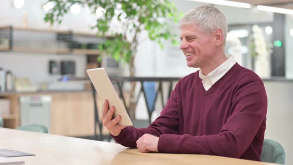 Middle Aged Man Doing Video Chat on Tablet at Home