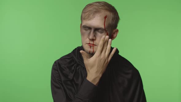 Man Executioner Halloween Makeup and Costume. Guy with Blood on His Face