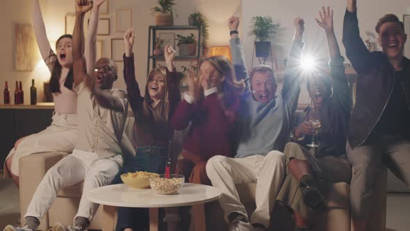 Excited Young People Cheering while Watching Movie