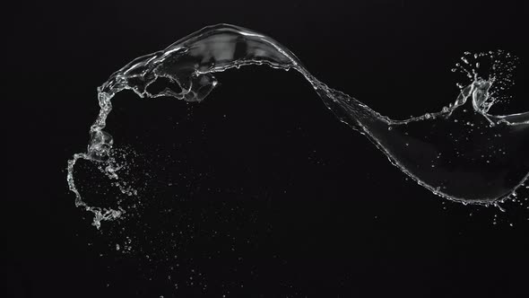 Water splash in midair against black background. Slow Motion. Unedited version included.