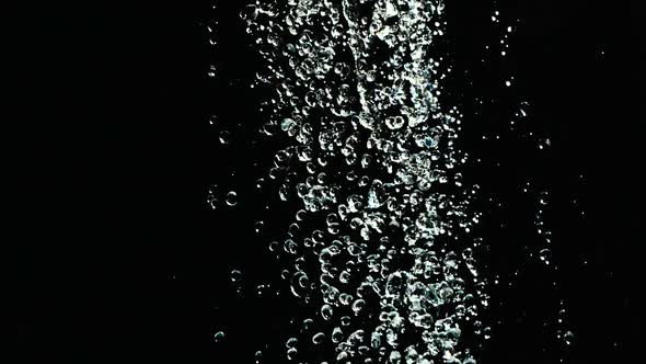 Falling Water Drops in Slow Motion on Black Background. Falling Water Droplets Against Black