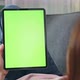 Woman holding in hands a digital tablet with green screen for internet online. - VideoHive Item for Sale