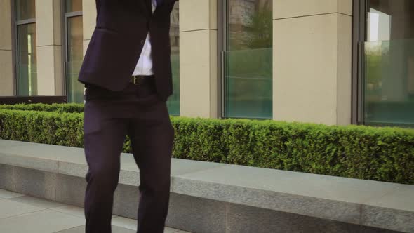 Happy Successful Businessman Dancing In Wireless Earphones