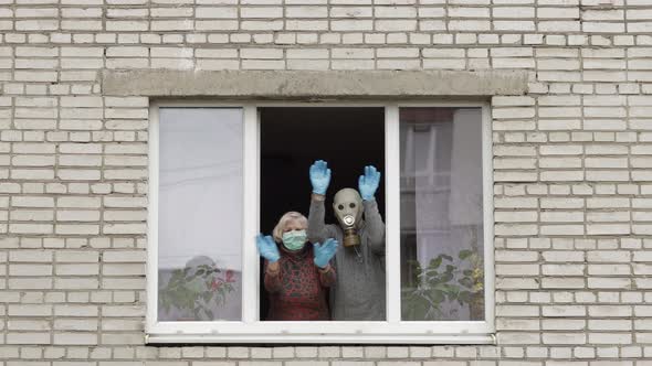 Old Grandparents Stay at Window Isolated at Home on Quarantine. Coronavirus alt