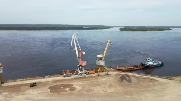 Large Harbor Cranes on the Shore at the Pier