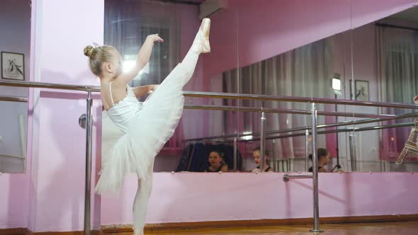 Ballet. Cute ballerina dancing in the studio. Beautiful young dancer. A ballerina is posing.