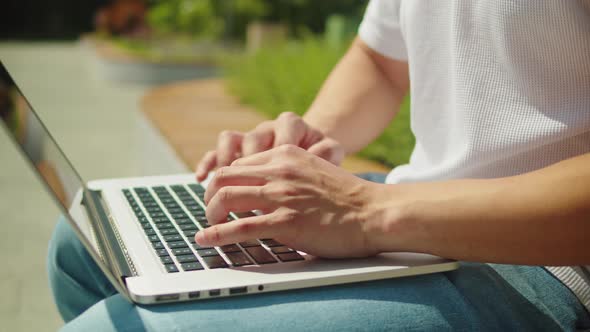 Man Using Laptop Outdoor Closeup