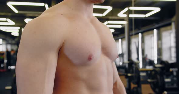 Bodybuilder In The Gym Playing Chest Muscles