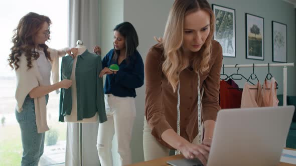 Women working on their new collection in workshop. Shot with RED helium camera in 8K