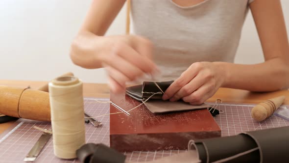 Woman making leather craft at home