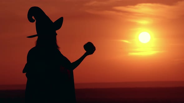 Girl in Fancy Dress and Hat Evil Sorceress Sunrise View