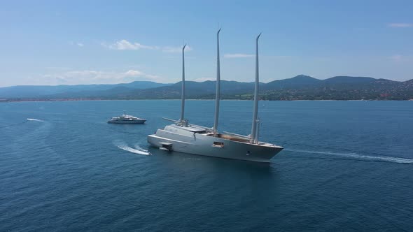 Aerial view of a yacht and many boats along the coast, France.