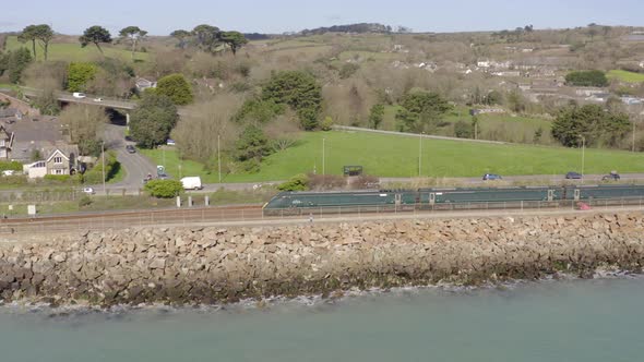 Commuter Train Alongside the Sea Aerial View