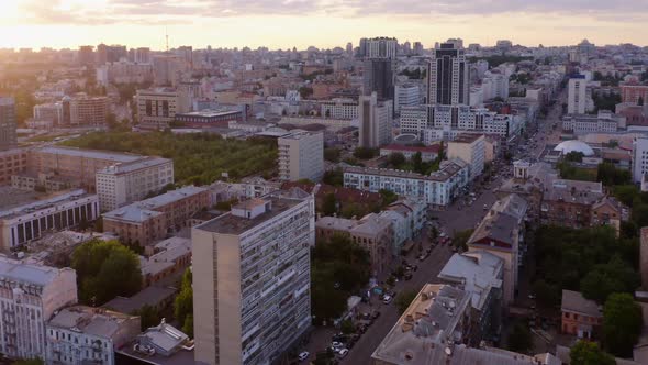 Aerial View of City Buildings with Car Traffic During Sunset