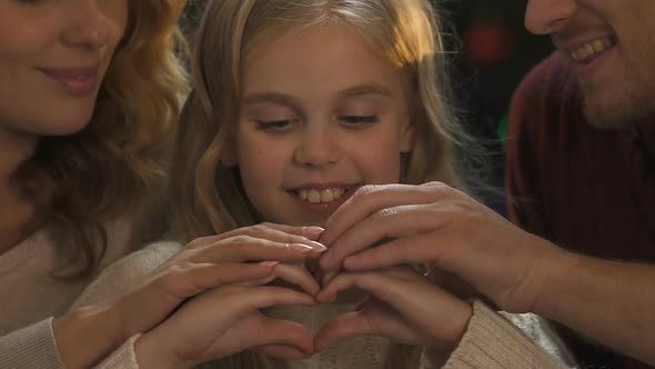 Friendly Family Making Heart With Hands, Love and Care, Christmas Celebration