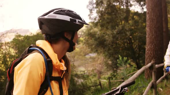 Mountain biker couple taking a break while biking