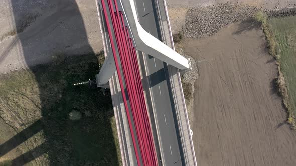 Vehicles Crossing a Cable Stayed Suspension Bridge Crossing a River