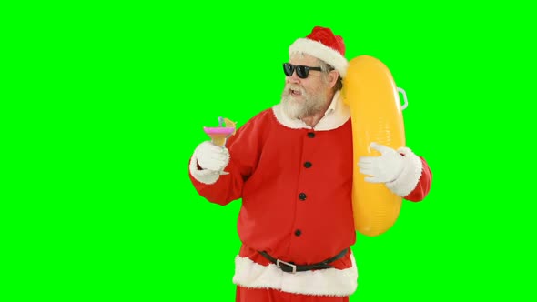 Santa claus holding inflatable tube and cocktail