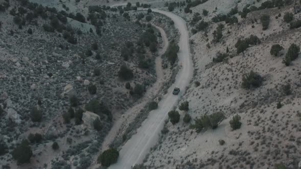 Drone shot of truck driving through desert. Drone shot of truck driving down dirt road. Vehicle driv