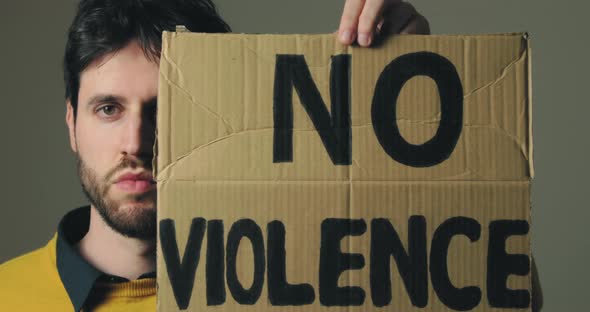 Ukrainian Boy Holding a No Violence Placard in His Hand