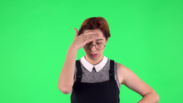 Portrait of Funny Girl in Round Glasses Tired. Green Screen